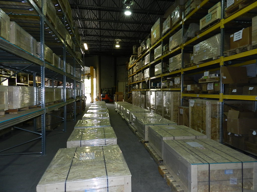 Deep warehouse aisle view with fully stocked shelving on both sides